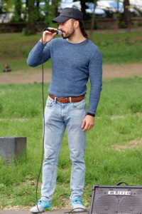 Young man singing with a microphone and speaker